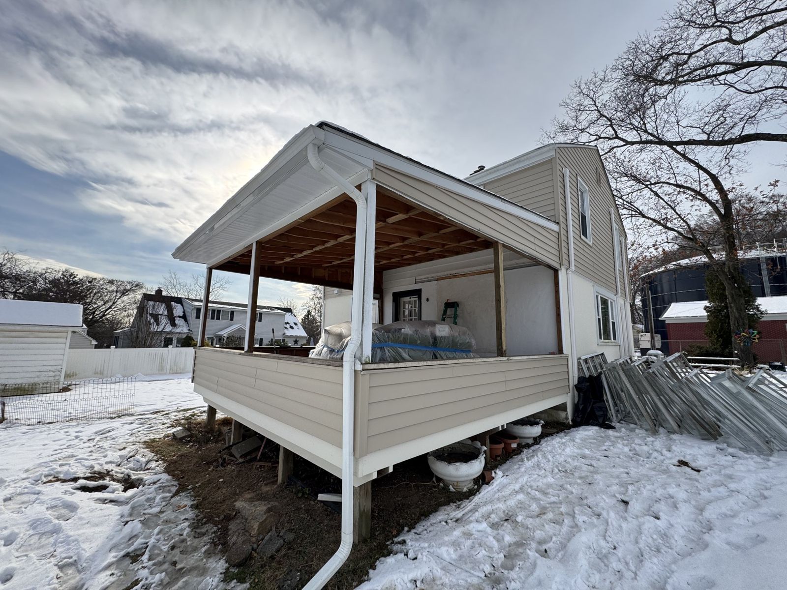 Open covered porch on the back of the house before the enclosure